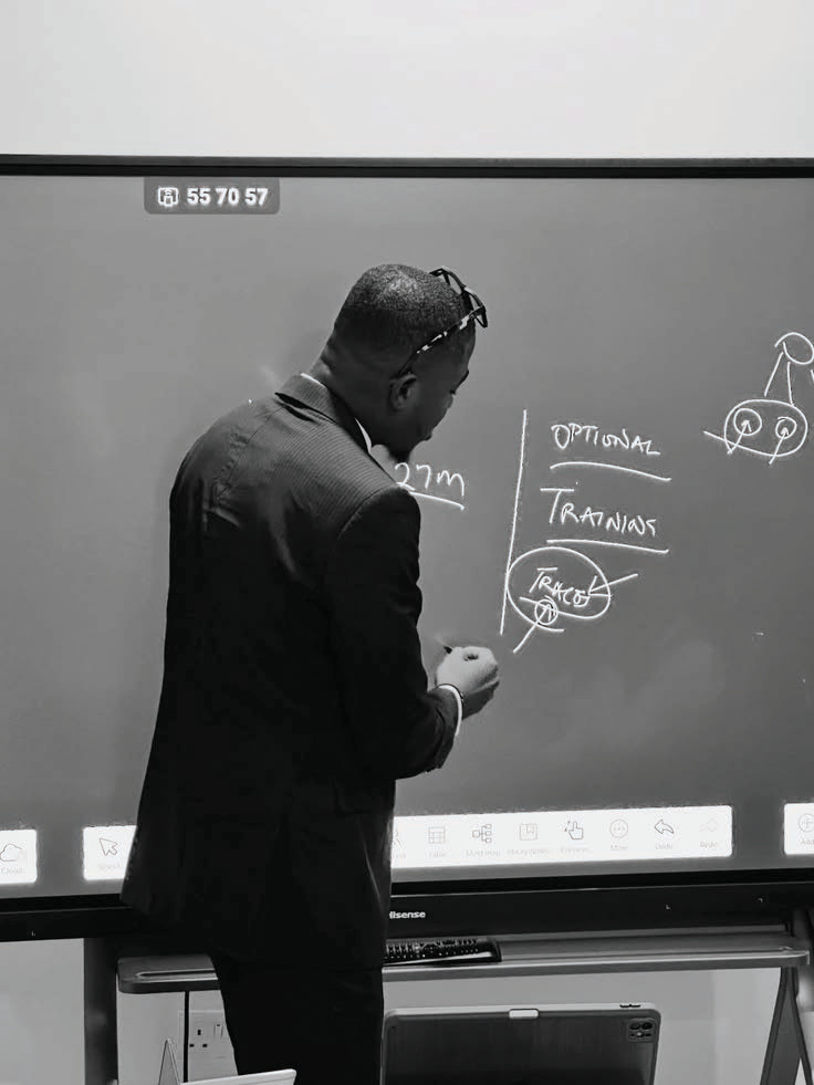 An educator explaining ideas at a board